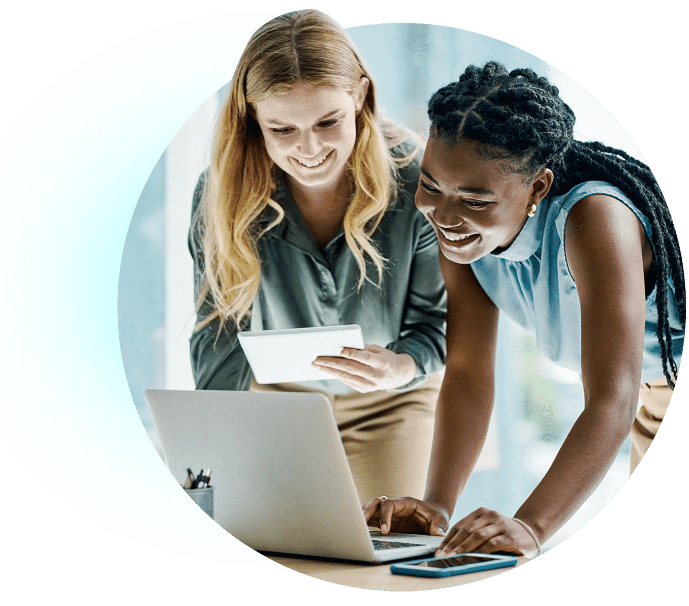 Two women collaborating over a laptop